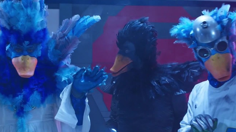 Blue alien duck scientists standing