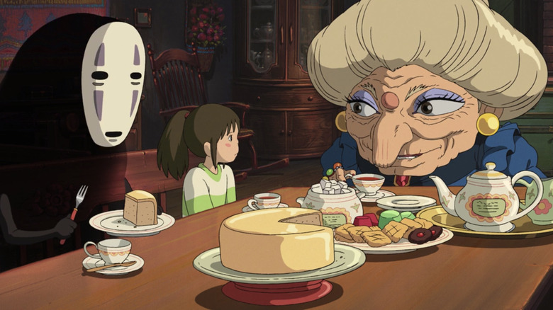 Chihiro sitting down to a meal with Zeniba