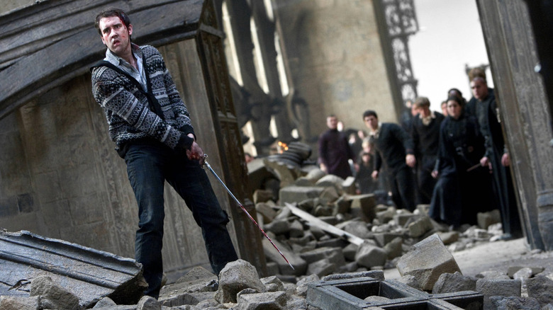 Neville holding sword in rubble