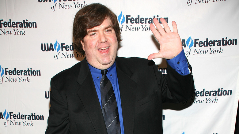 Dan Schneider waving and smiling