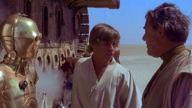 C-3PO, Luke Skywalker, and Owen Lars on Tatooine 