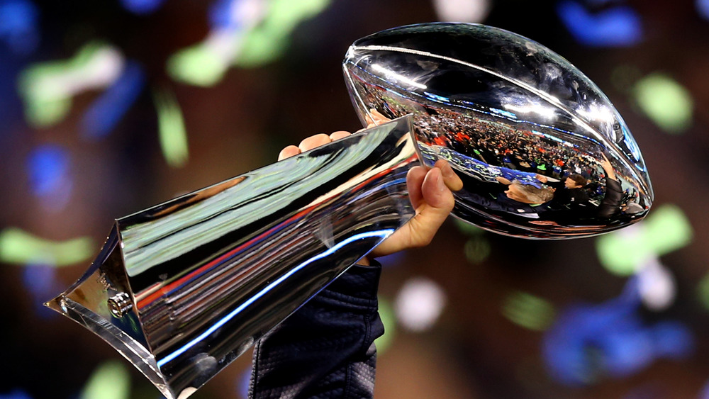 Hand raising the Vince Lombard Trophy