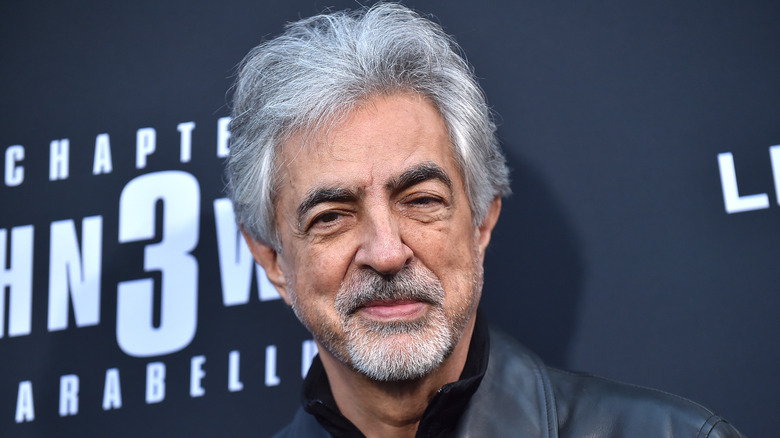 Mantegna smirking for press photo