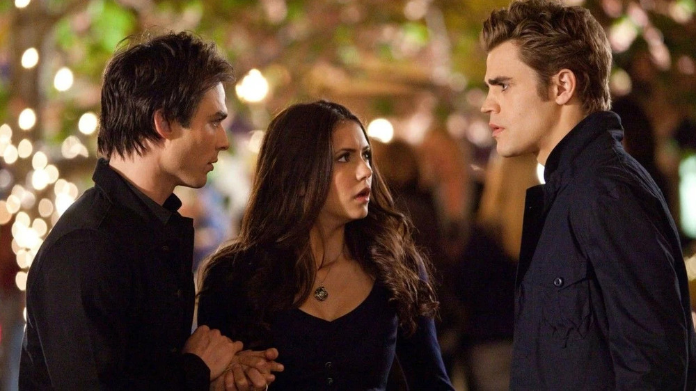 Elena in between Damon and Stefan on The Vampire Diaries