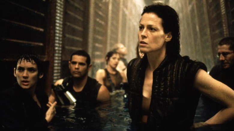 Ripley and the crew standing in waist-high water