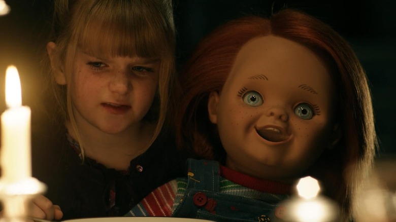 Alice and Chucky behind candles