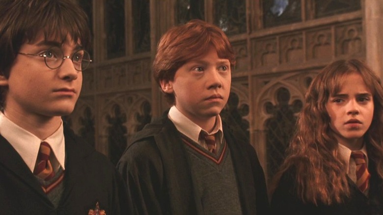 Harry, Ron, and Hermione in Great Hall