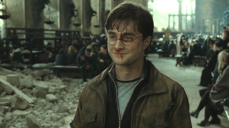 Bloodied Harry Potter smiling