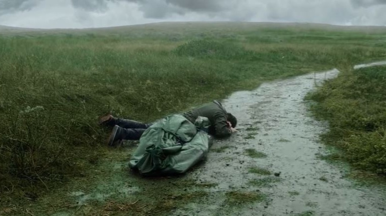 Charlie crying on a mountain with his dad's corpse