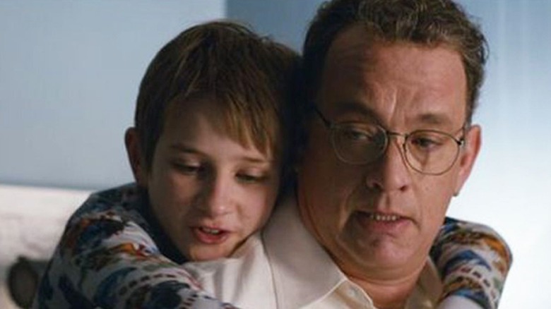 Boy hugging Tom Hanks