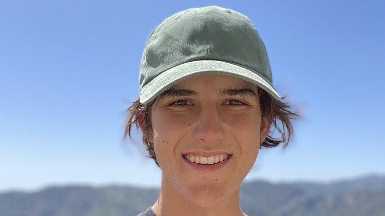 Aidan Barton smiling with baseball hat