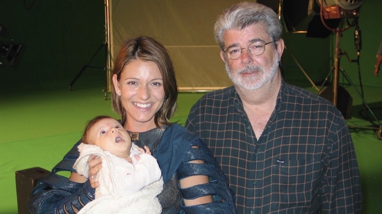 Baby Barton, his mom, and George Lucas posing together