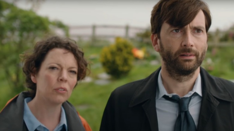 David Tennant and Olivia Colman staring