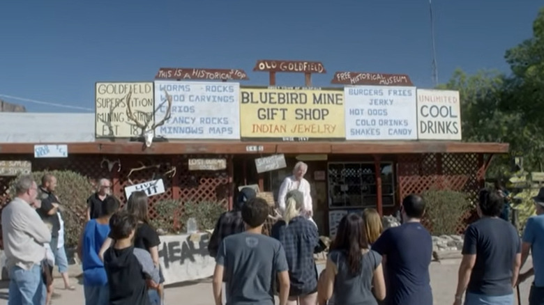 People forming a crowd outside small store