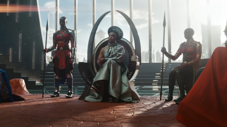 Queen Ramonda on the throne flanked by the Dora Milaje