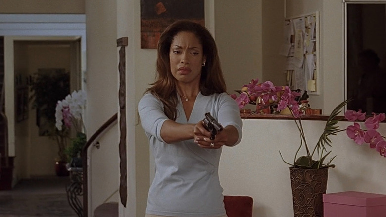 Gina Torres pointing a gun