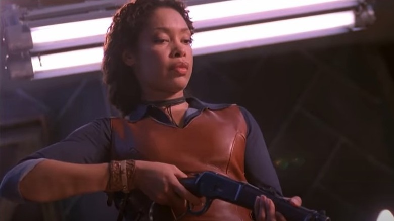 Gina Torres pointing a gun