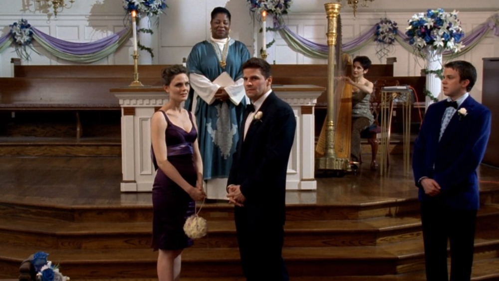 Bones and Booth stand at the altar 