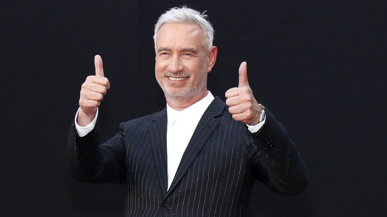 Roland Emmerich flashing a double thumbs up 