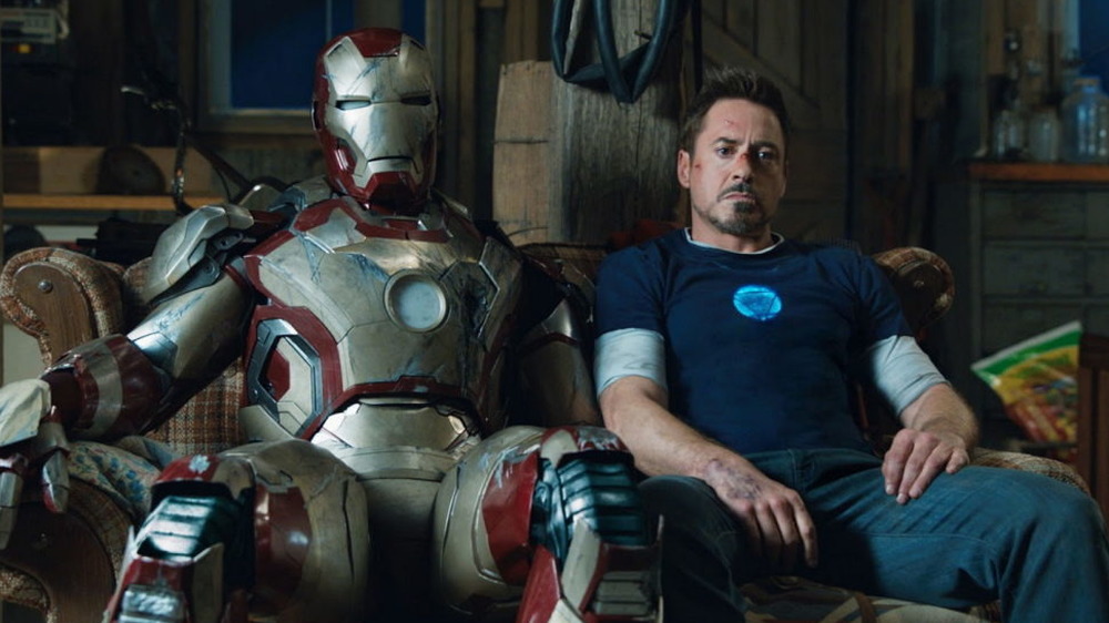 Tony Stark sitting with suit