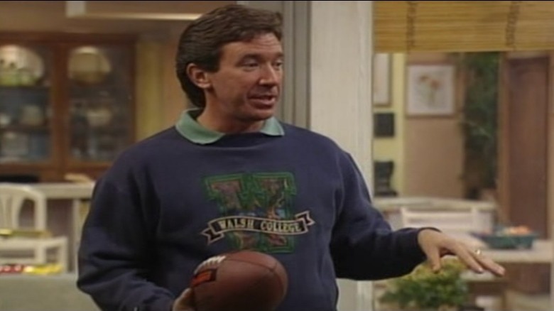 Tim Taylor holding a football