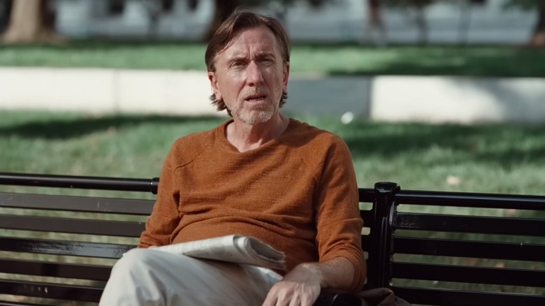 Tim Roth as David sitting on a bench