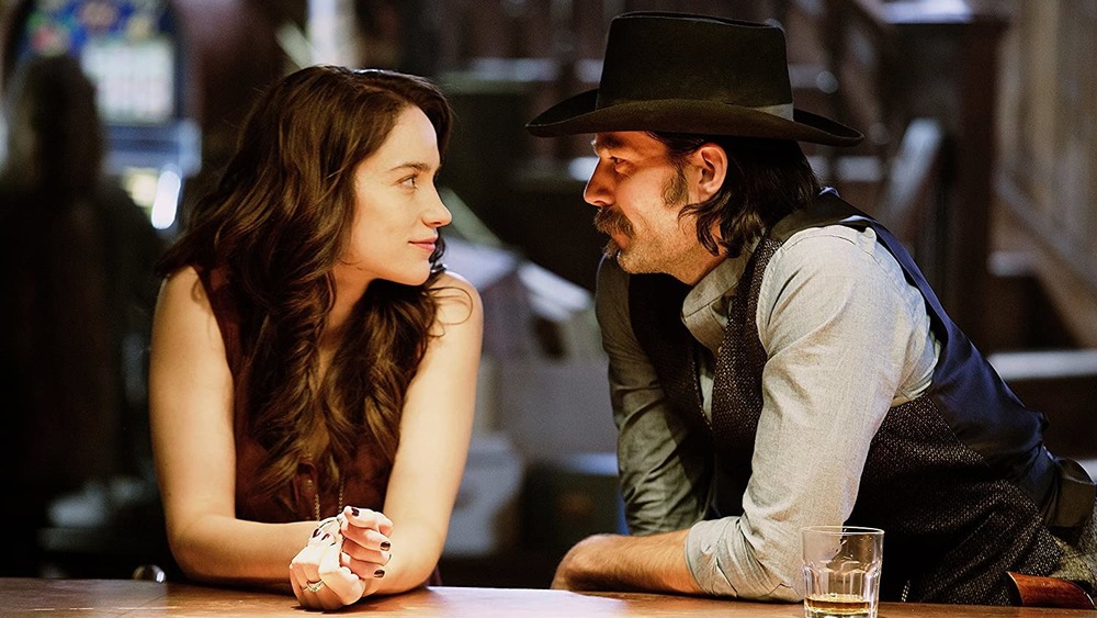 Melanie Scrofano and Tim Rozon gaze into each other's eyes at a bar on Wynonna Earp