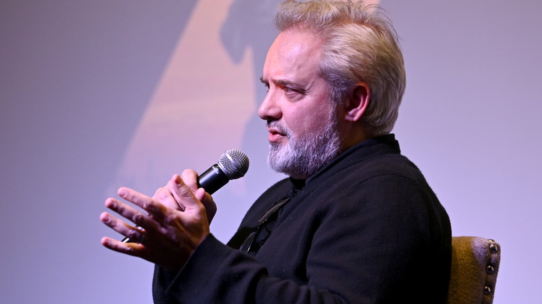 Sam Mendes holds microphone