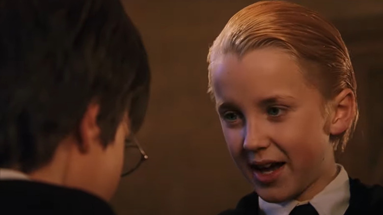 Draco talking to Harry