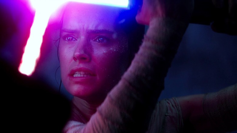 Rey (Daisy Ridley) locked in a lightsaber battle in "Star Wars: The Force Awakens"