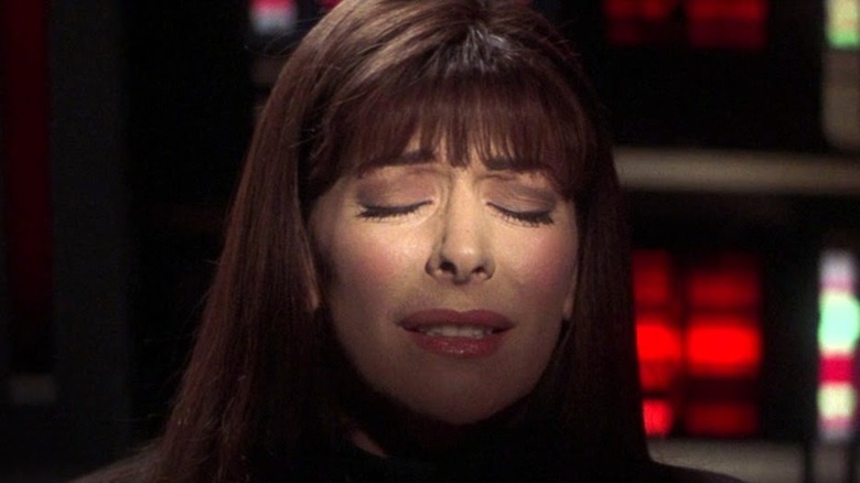 Troi squints in anguish