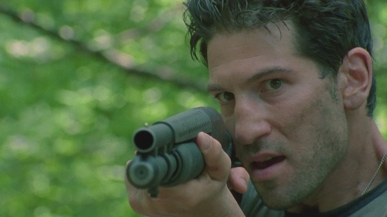 Shane aiming a shotgun