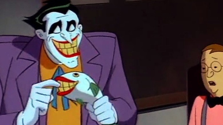 Joker holding laughing fish