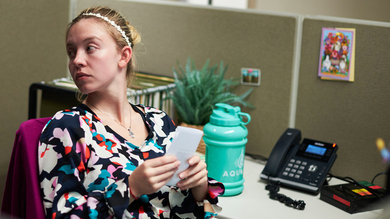 Sydney Sweeney sitting at desk