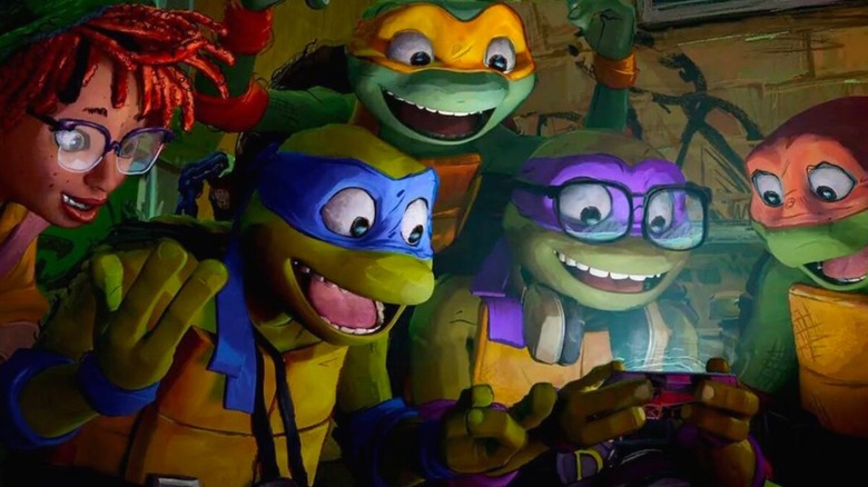 The TMNT and April looking at a screen