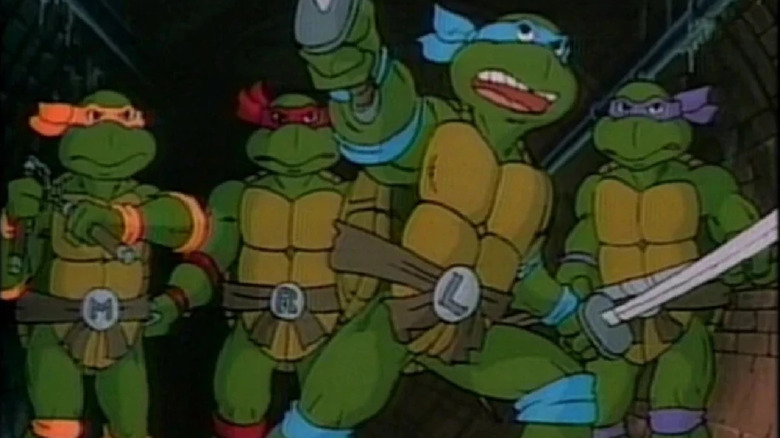 Teenage Mutant Ninja Turtles drawing their weapons