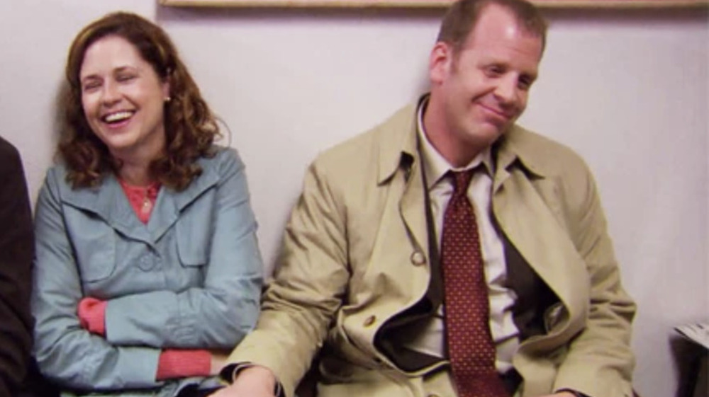 Toby with hand on Pam's knee