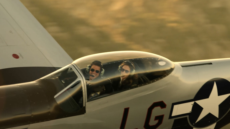 Maverick and Penny flying in P-51 Mustang