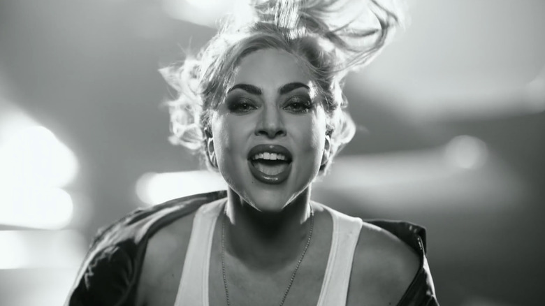 Lady Gaga wearing flight jacket and white tanl top
