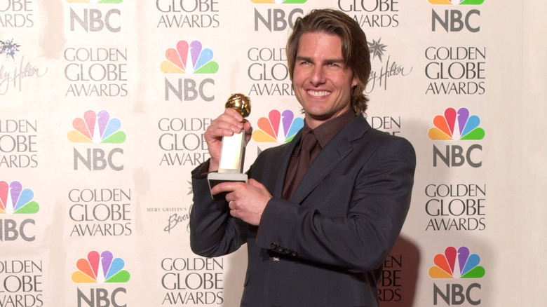 Tom Cruise holding Golden Globes award