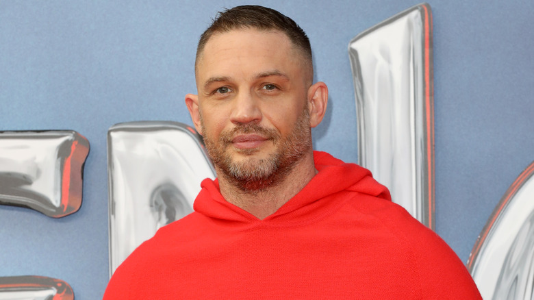 Tom Hardy smiling red hoodie