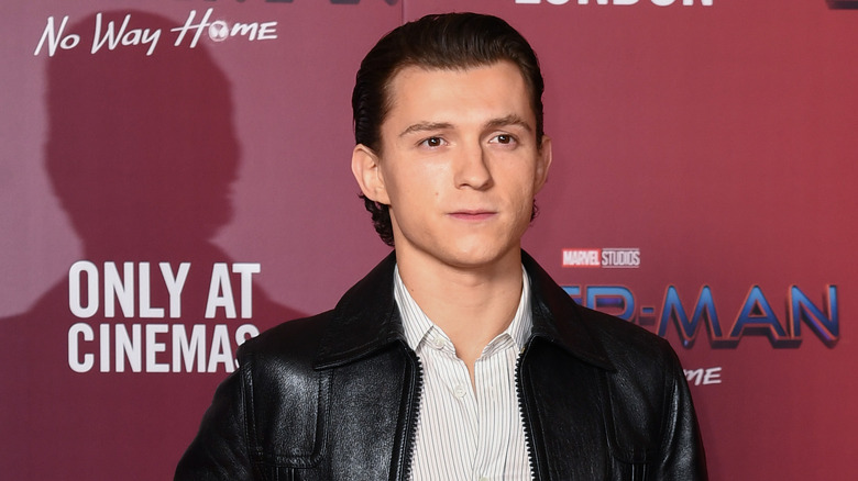 Tom Holland looking seriously at camera