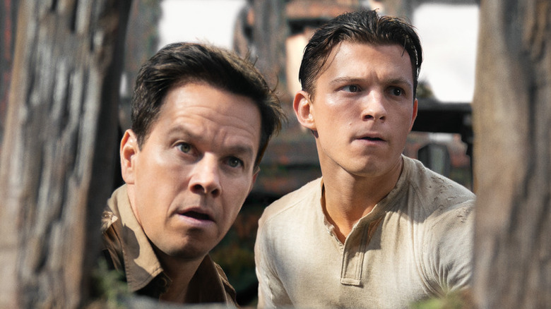 Mark Wahlberg and Tom Holland looking around in Uncharted