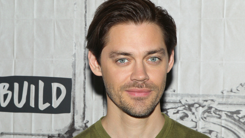 Actor Tom Payne smiling