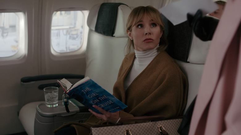 Anna reading a thriller on a plane