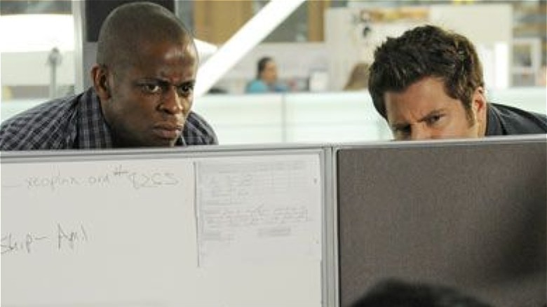 Shawn and Gus spy over a cubicle