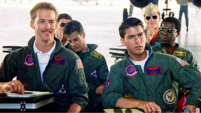 Maverick and goose sit in classroom with other pilots