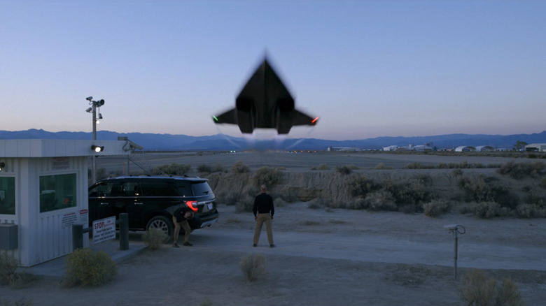 A jet flies over Ed Harris