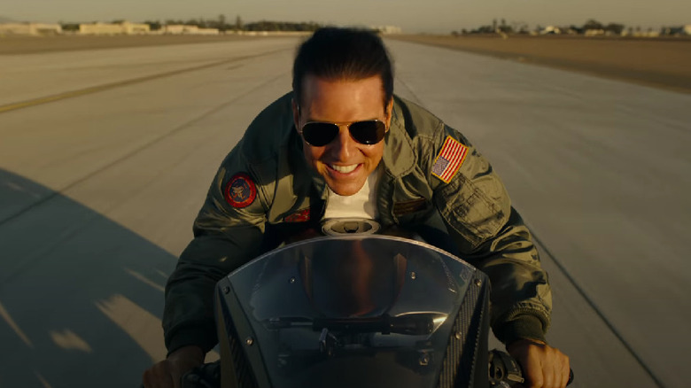 Maverick smiling while riding fast on his motorcycle