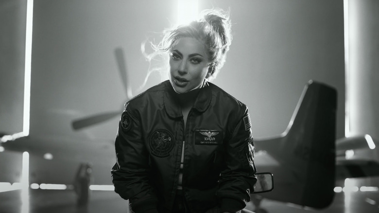 Lady Gaga pilot uniform, plane in background